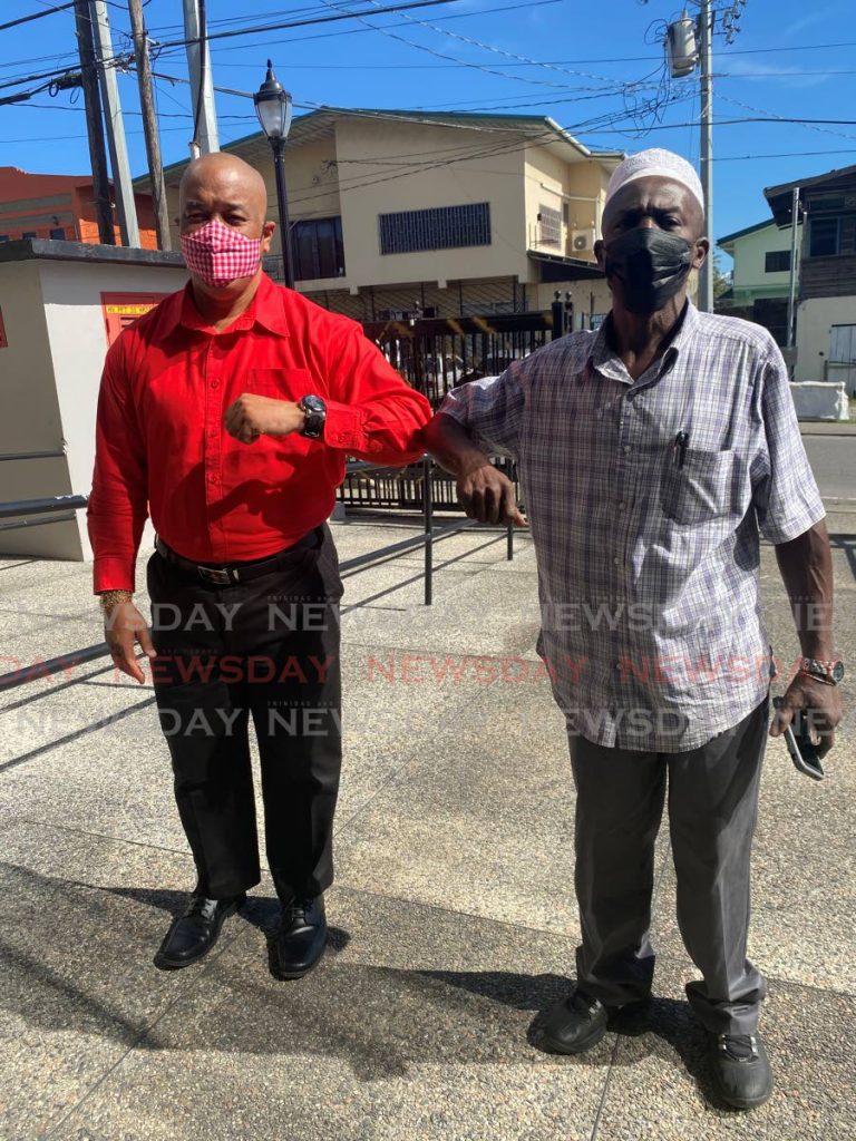 UNC nominee for Hollywood Daniel John (right) poses with PNM candidate Leslie Chang Fong at the Patrick Gordon Building, Point Fortin on Monday.  - Narissa Fraser