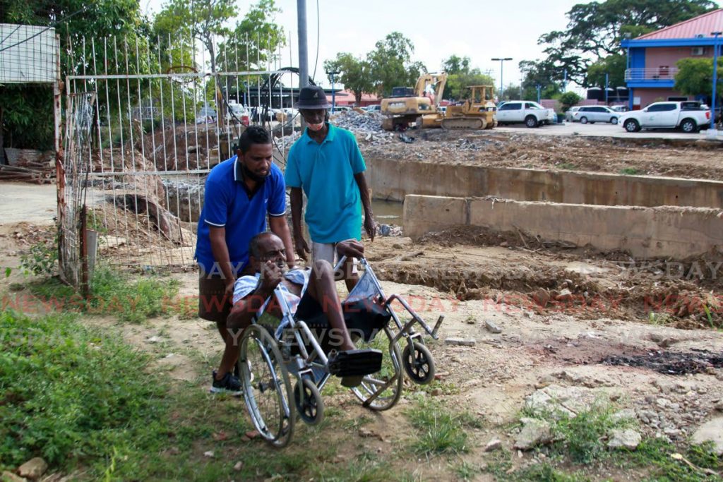 WOES: Wheelchair-bound Vinda Bachan on his San Juan property which he said has been virtually cut off by construction work being done by the Ministry of Works’s Drainage Division. PHOTO BY ROGER JACOB  - 