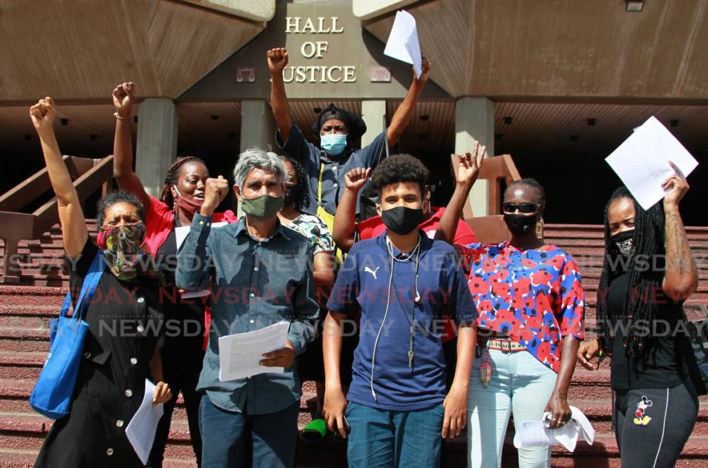 Members of a criminal injustice lobby group, co-ordinated by Wayne Kublalsingh and Nazma Muller at the front of the Hall of Justice in Port of Spain on Friday.  - ROGER JACOB