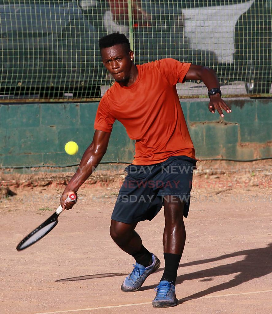 Ronald Robinson attempts a forehand against Adisa Idemudia in the men's singles at the Shell Tranquillity Open Tennis tournament at the Tranquillity Tennis Courts, Victoria Avenue, Port of Spain, on Friday. PHOTO BY ROGER JACOB - ROGER JACOB