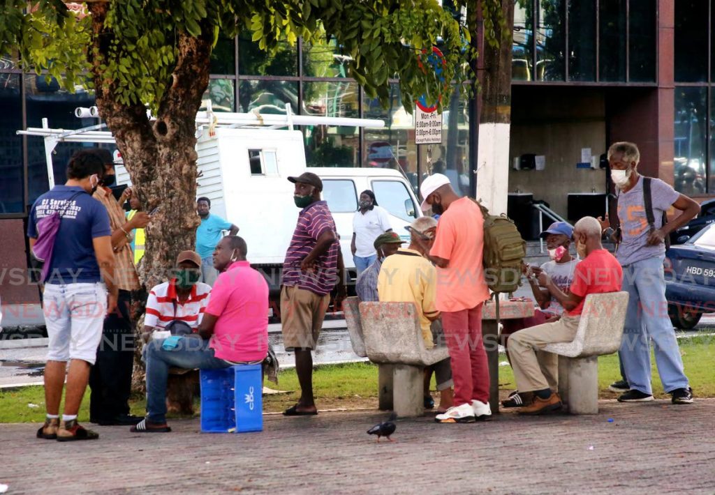 Promenade Lime: Newsday photographer Sureash Cholai, captured this group of men who usually gather everyday to play cards and make a lime on the Brian Lara Promenade in Port of Spain in January 2021. No social distancing was observed with some opting to wear their face masks incorrectly. 