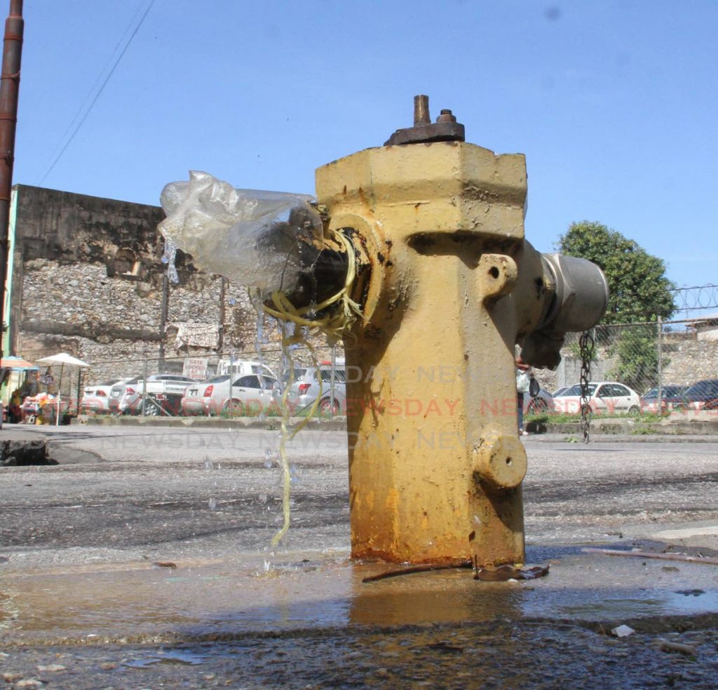 File photo: A bottle being used to stop this leaking fire hydrant from wetting pedestrians at Tamarind Square, Nelson Street, Port of Spain on Tuesday Photo by Angelo Marcelle