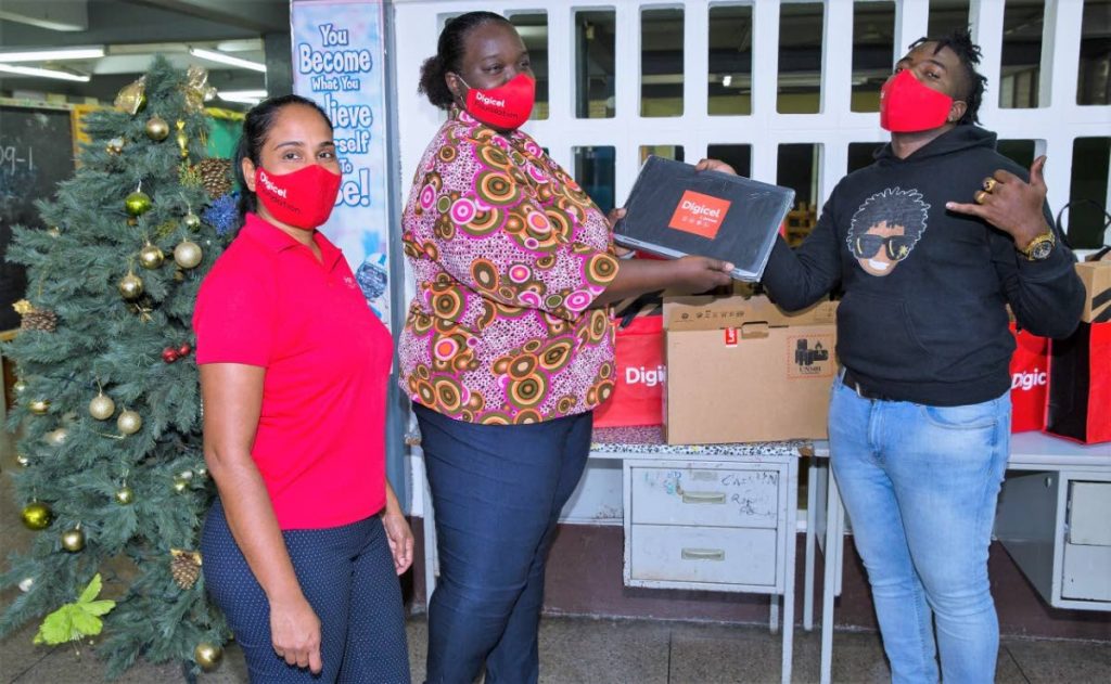 Akeem “Preedy” Chance is excited to display one of the donated laptops at a brief handover held in December. The devices will go a long way in ensuring connectivity for some of the students of the Maloney Government Primary School. - 