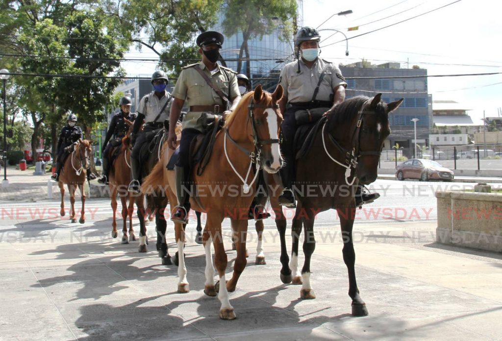 Officers of the Mounted Branch ride their horses through the Brian Lara Promenade, Port of Spain. - AYANNA KINSALE