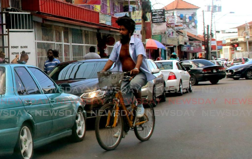 Beating the traffic, this  man cycled his way along Saddle Road in San Juan. - SUREASH CHOLAI