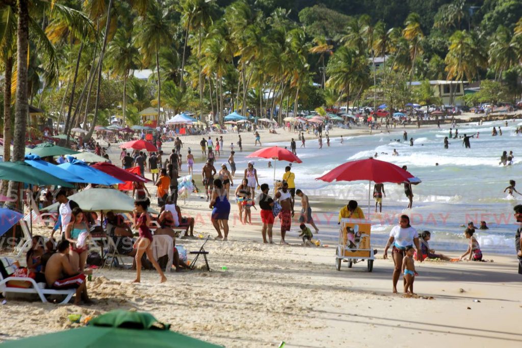 A large number of beachgoers enjoy the sand, sea, sun and scenery at Maracas Bay. - SUREASH CHOLAI