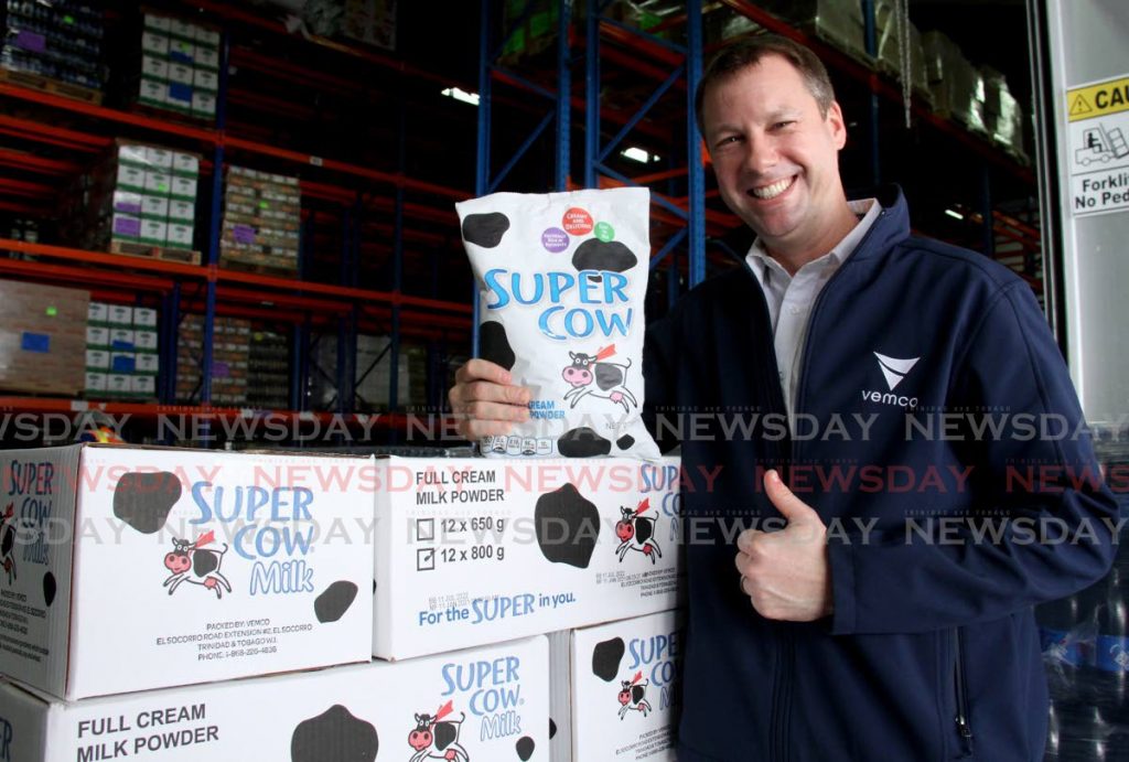 CEO of VEMCO Christopher Alcazar smiles with a pack of Super Cow milk.  - AYANNA KINSALE