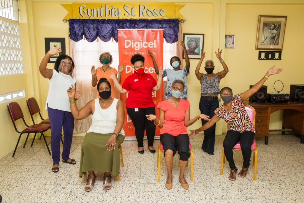 Several members of the Coterie of Social Workers' Barataria branch celebrate one of the its freshly painted rooms. - 