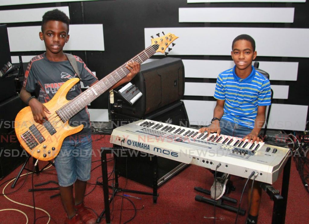 
Joshua Tuckett, left, plays the bass guitar while his brother Isaiah plays the keyboards at Sui Generis Sound Drumming Academy, Longdenville. - 
