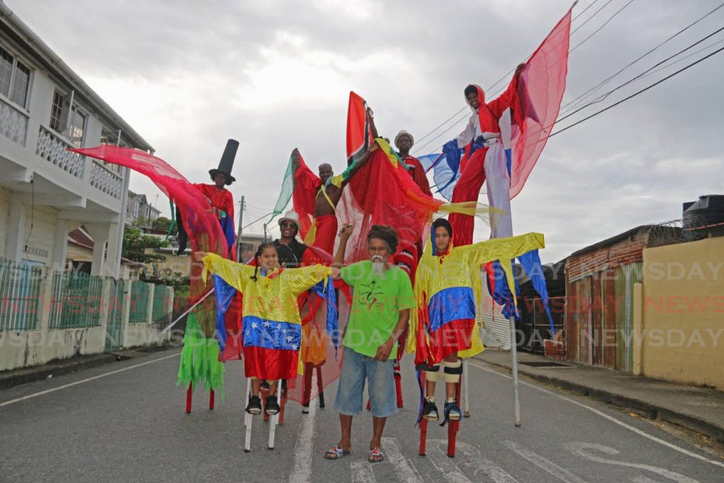 Kaisokah School of Arts founder Junior Bisnath, centre, with moko jumbies on Henry Street, San Fernando. Bisnath is preparing for relay of moko jumbies from San Fernando to Port of Spain in solidarity with countries that have been greatly affected by the covid19 pandemic. Among the countries highlighted in the costumes is Venezuela.

PHOTOS BY MARVIN HAMILTON - 