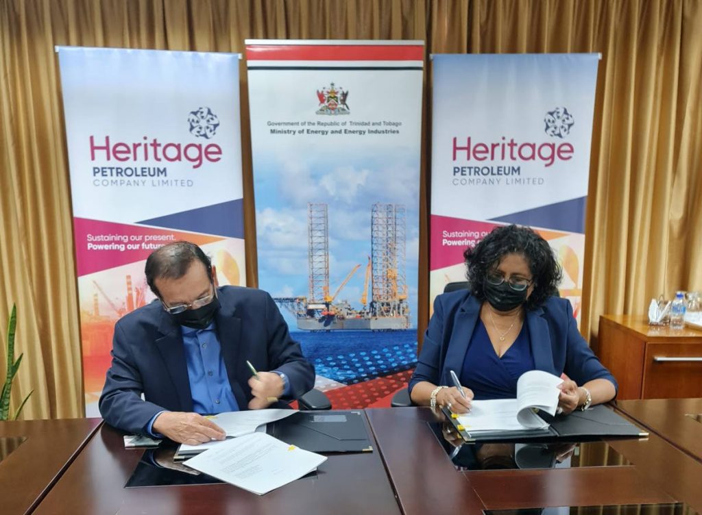 Minister of Energy and Energy Industries Franklin Khan and Heritage Petroleum CEO Arlene Chow sign a new licence agreement for two blocks off the west coast of Trinidad on Wednesday. The exploration deal is worth $100 million. PHOTO COURTESY THE MINISTRY OF ENERGY AND ENERGY INDUSTRIES. - 