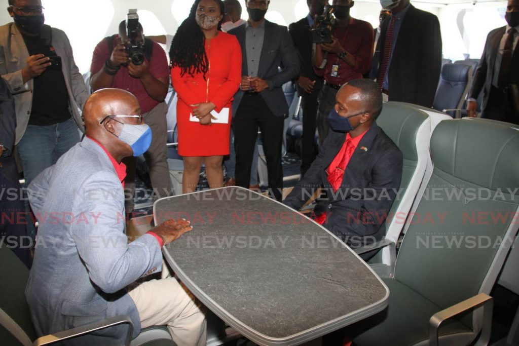 TABLE TALKS: PM Keith Rowley, left, and THA Chief Secretary Ancil Dennis have a chat while checking out the new fast ferry APT James during its commissioning at the Scarborough port on Thursday.

enjoy the seating on the newly commissioned APT James passenger fast ferry at the Scarborough Port, Tobago on Thursday. - Angelo Marcelle