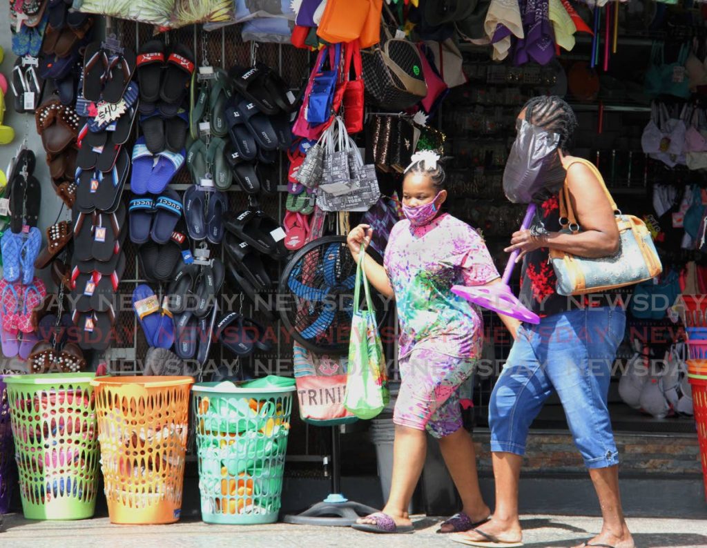 A woman and a girl out shopping in Arima on January 23. Ministry of Health officials warn of a rise in covid19 cases in St George East communities such as Arima. PHOTO BY ANGELO MARCELLE - 