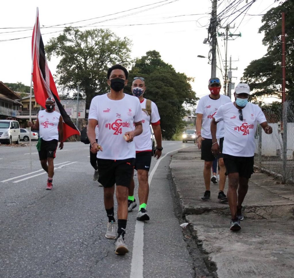 TTOC president Brian Lewis (front) leads a group of walkers during their participation at the virtual TT International Marathon, from Freeport to the Queen's Park Savannah in Port of Spain, on Sunday. PHOTO COURTESY TTOC. - 