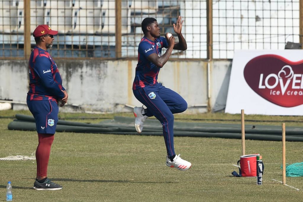 West Indies' fast bowler Alzarri Joseph (right) delivers a ball as coach Phil Simmons watches during a practice session at the Zohur Ahmed Chowdhury Stadium in Chittagong on Sunday. (AFP PHOTO)  - 