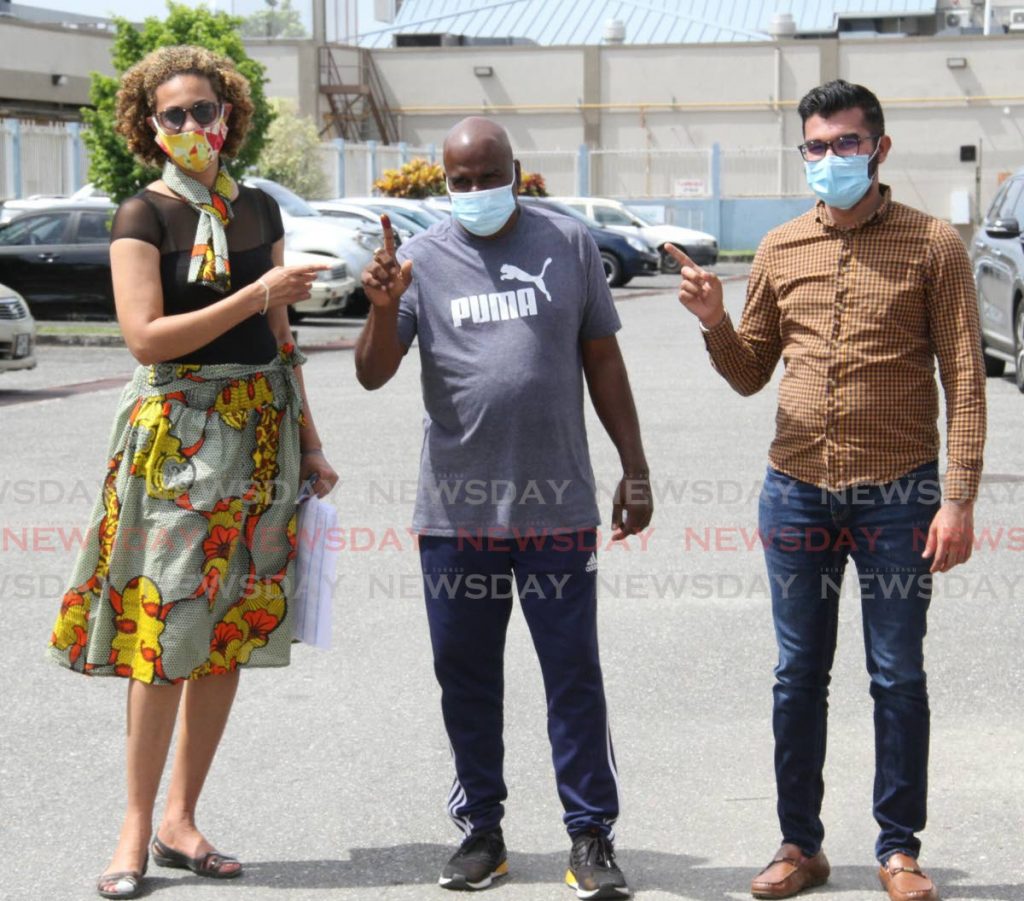 UNC's Arima Central LGE by-election candidate Sheldon 'Fish' Garcia, centre,  is accompanied by UNC St. Augustine and San Juan/Barataria MPs Khadijah Ameen on left and Saddam Hussein. Garcia voted at the Arima New Government Primary School. - Angelo Marcelle
