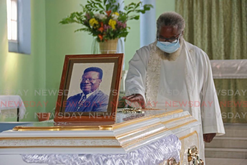 Fr. Wilson Thomas (Bassey), cousin of Clifton De Coteau performed final rights at the St Stephen's Anglican Church in Princes Town on Monday. - Marvin Hamilton