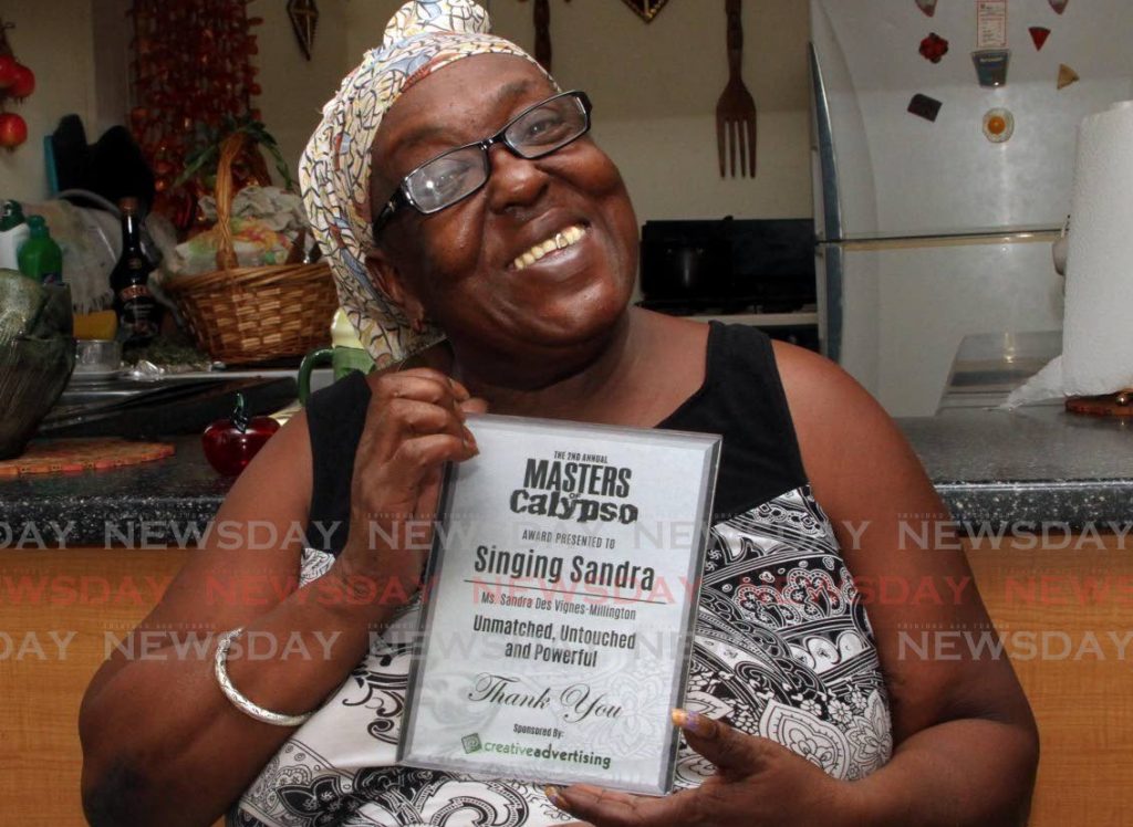 National treasure Sandra “Singing Sandra” Des Vignes Millington proudly holds up her Masters of Calypso award at her Cashew Gardens home on July 27, 2017. FILE PHOTO  