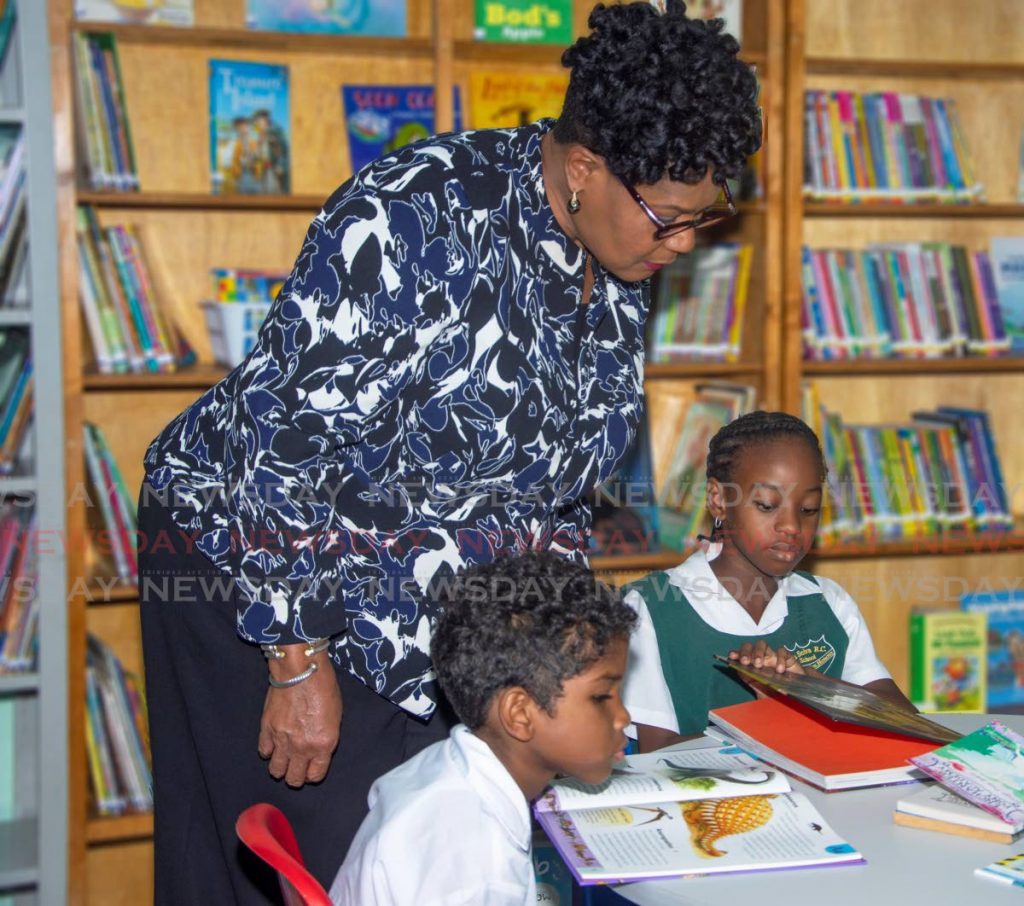 In this November 18, 2019 file photo, President Paula-Mae Weekes chats with students of La Seiva RC School, Maraval in their new library. Schools have been closed since March 2020 with learning moving online because of the covid19 pandemic.  - 