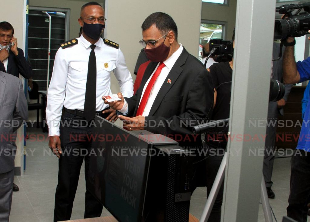 Works and Transport Minister Rohan Sinanan checks his driver's permit under the watch of Transport Commissioner Clive Clarke at the opening of the Licensing Division office in Guaico, Sangre Grande on July 24, 2020. PHOTO BY AYANNA KINSALE - 