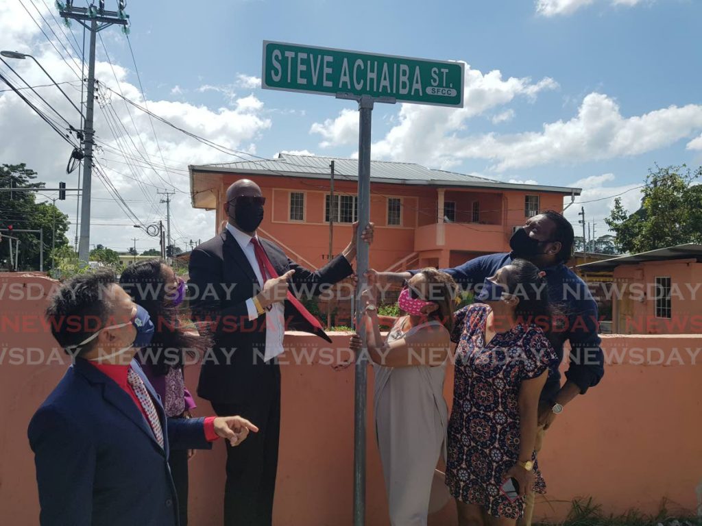 San Fernando mayor Junia Regrello unveils the Steve Achiba street sign in honour of the former steelband icon who brought national pride to San Fernando when he led Hatters to win its only national panorama title . With Regrello are Achiba's wife Candice, daughter Adriana and son Jonathan. - Yvonne Webb 
