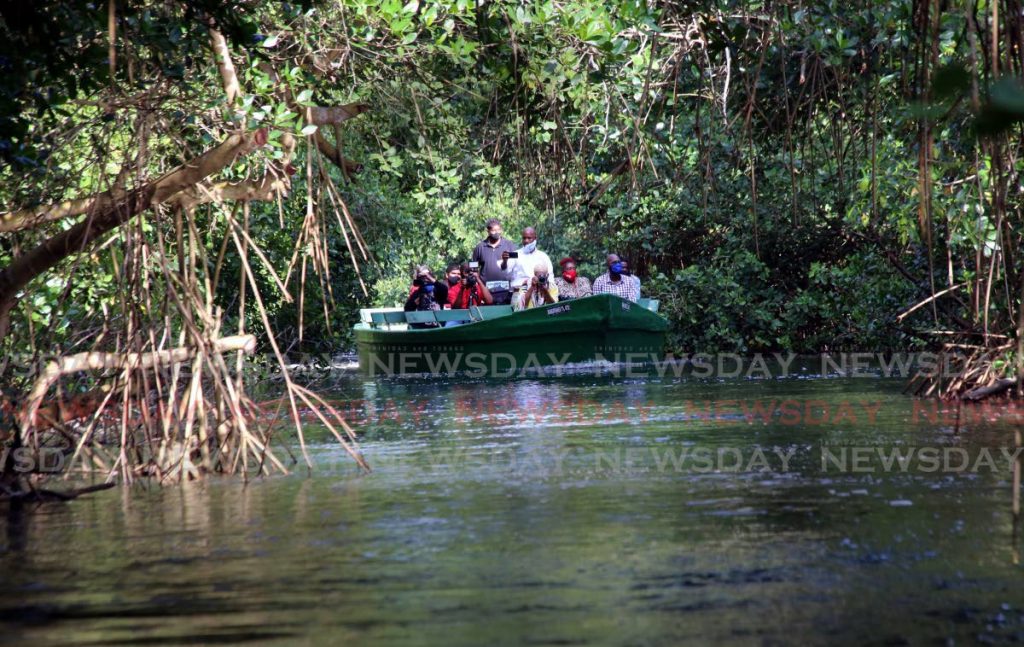 A tour boat with visitors on the Caroni Bird Sanctuary mangrove swamp.
 - Sureash Cholai