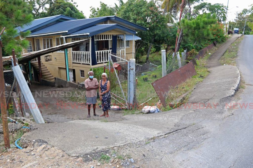 HELP NEEDED: San Francique couple Ramhit Narine and his wife Marilyn, both 77, are pleading with Works and Transport Minister Rohan Sinanan to fix the landslips in the area which are affecting their home. - Marvin Hamilton
