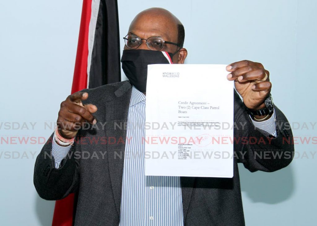 Opposition Senator Wade Mark shows a document to the media during a news conference at the Office of the Opposition Leader in Port of Spain on Sunday. 

Displaying a document during a news conference at - Ayanna Kinsale