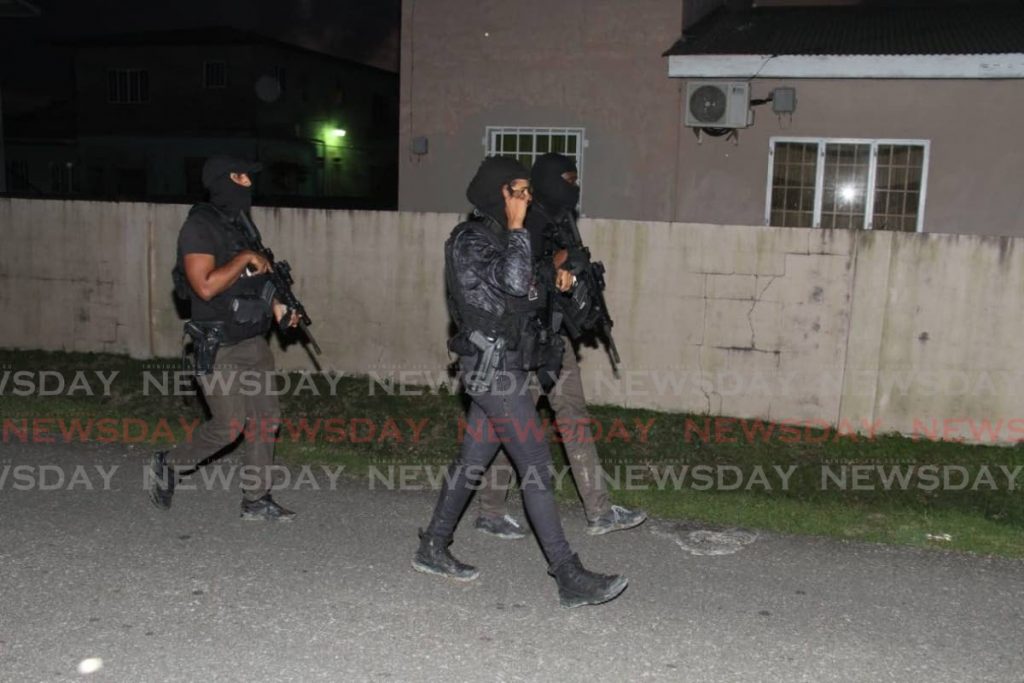 HUNT ON: Members of the Special Operations Response Team at Azalea Circular, Duranta Gardens, Sangre Grande last evening during their search for 22-year-old kidnapped woman Andrea Bharatt. - AYANNA KINSALE