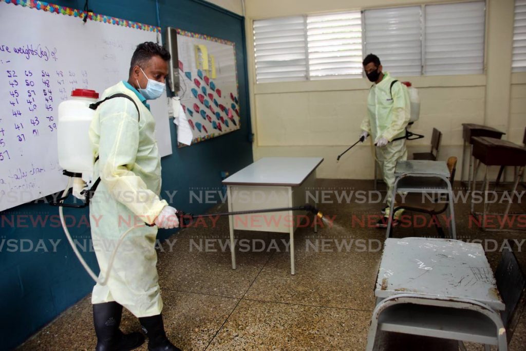 San Juan/Laventille Regional Corporation workers sanitise a classroom at Success/Laventille Secondary School in preparation for classes on Monday. Forms four to six students at secondary schools are due to resume classes in the first instance for practical learning, the Education Ministry has advised. File photo
