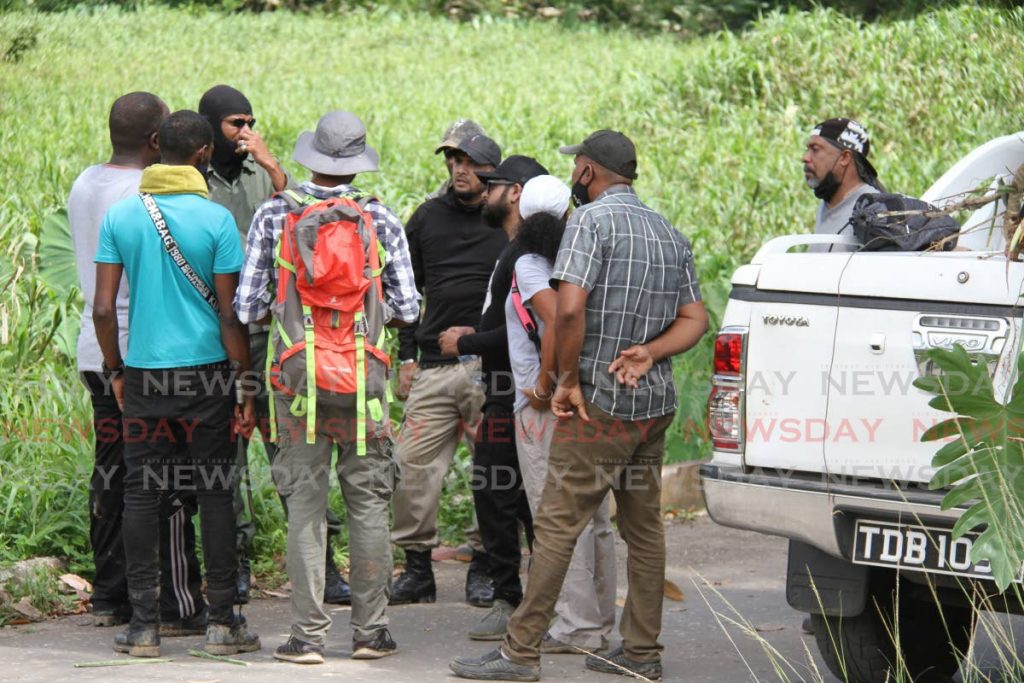 Members of the Hunting and Hiking Association, gather to look forAndrea Bharatt who was kidnapped recently. Photos by Angelo Marcelle