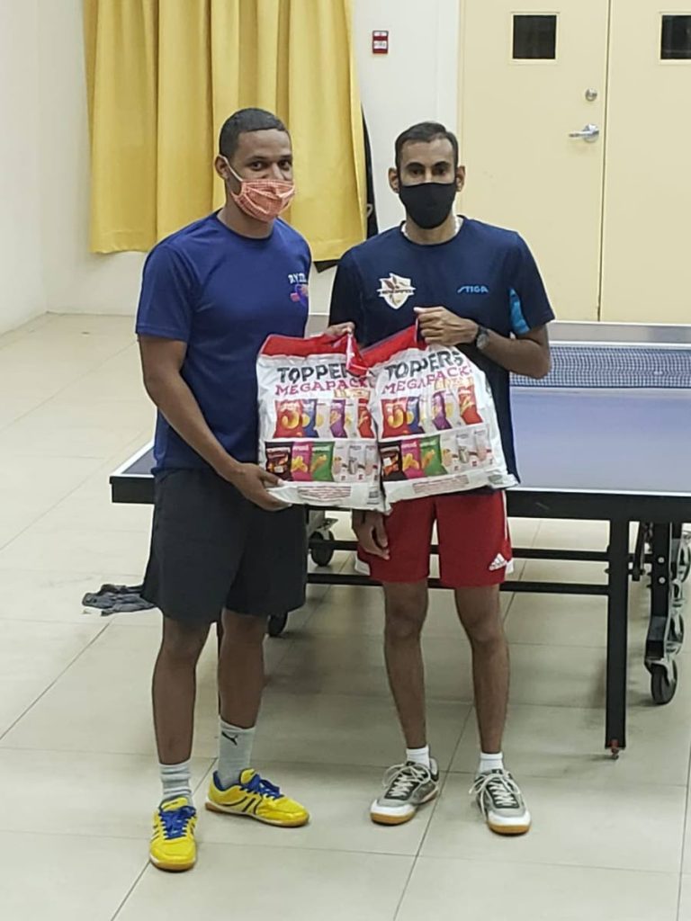 Sherdon Pierre (L),of D'Abadie Youths and Yuvraaj Dookram, of Renegades, display their hampers after their game in the TT Champions League table tennis tournament, at the D'Abadie Community Centre, on Tuesday. Dookram won 11-9,11-8,9-11,11-4. - Photo courtesy D'Abadie Youths 