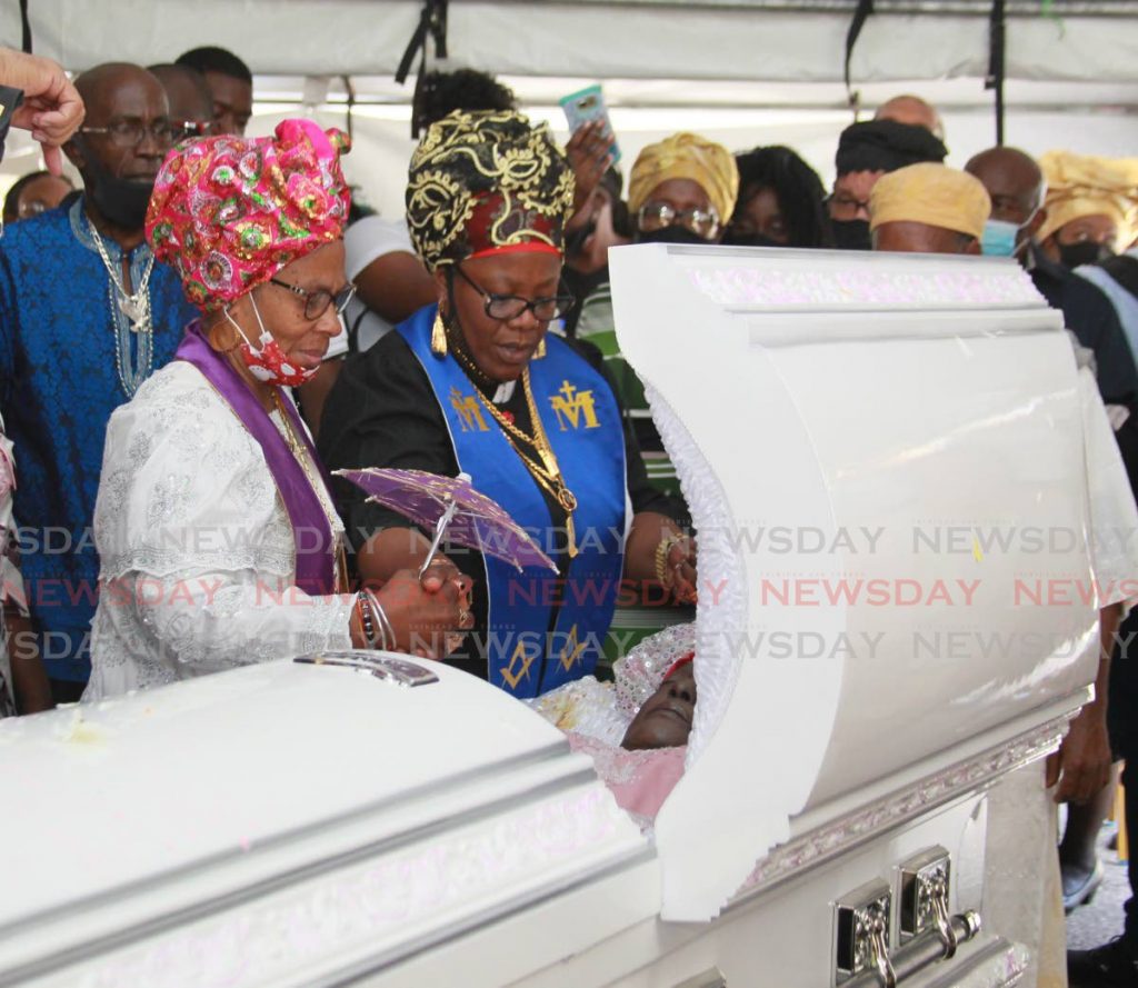 FINAL RITES: Officiating ministers Mother Indira Palmer and Mother Marilyn Ferguson pray over the body of former two-time national calypso monarch Sandra 
