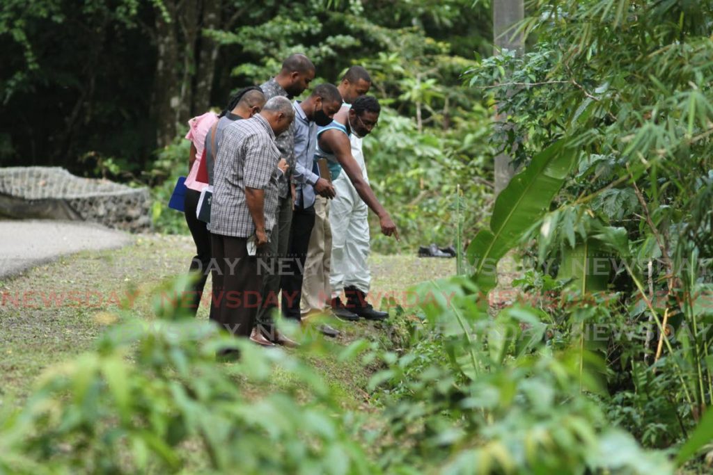 Police investigators look at the area where Andrea Bharatt's body was found in the Heights of Aripo on Friday afternoon. - Ayanna Kinsale