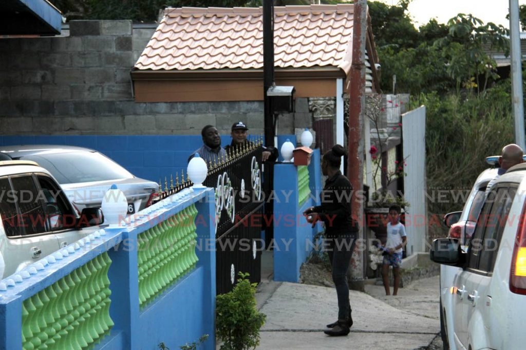 Police officers secure the home of Andrea Bharatt on Arima Old Road on Thursday evening. Bharatt's body was found down a precipice in Aripo that day. - Angelo Marcelle