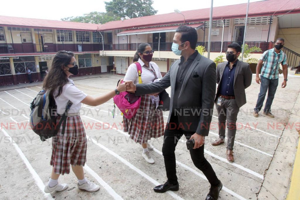 San Fernando West MP and Attorney General, Faris Al Rawi greets students of San Fernando Central Secondary on Monday as form five students return to school after being away due to covid19. - Lincoln Holder