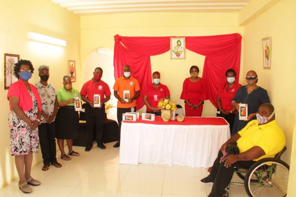 Students, parents, teachers and representatives from Digicel Foundation pose for a group photo at a handing-over ceremony at the Technical Vocational School for Persons with Disabilities, Bon Accord, Tobago last Friday. PHOTO COURTESY THA - 