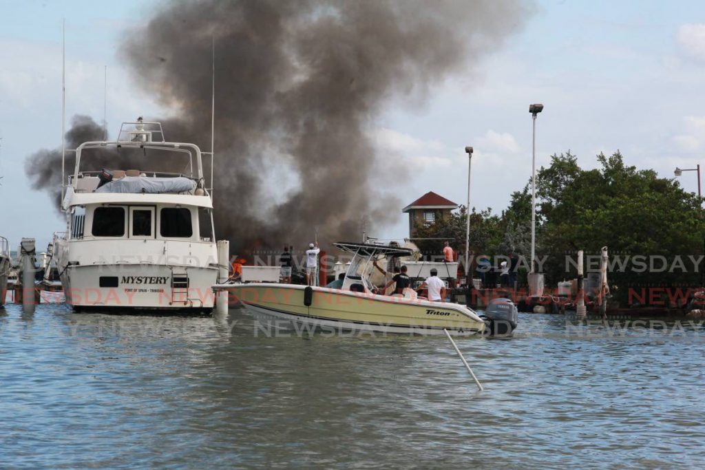 Fire razed two boats at the TT Yacht Club, Chaguaramas on Thursday. PHOTO BY ROGER JACOB  - 
