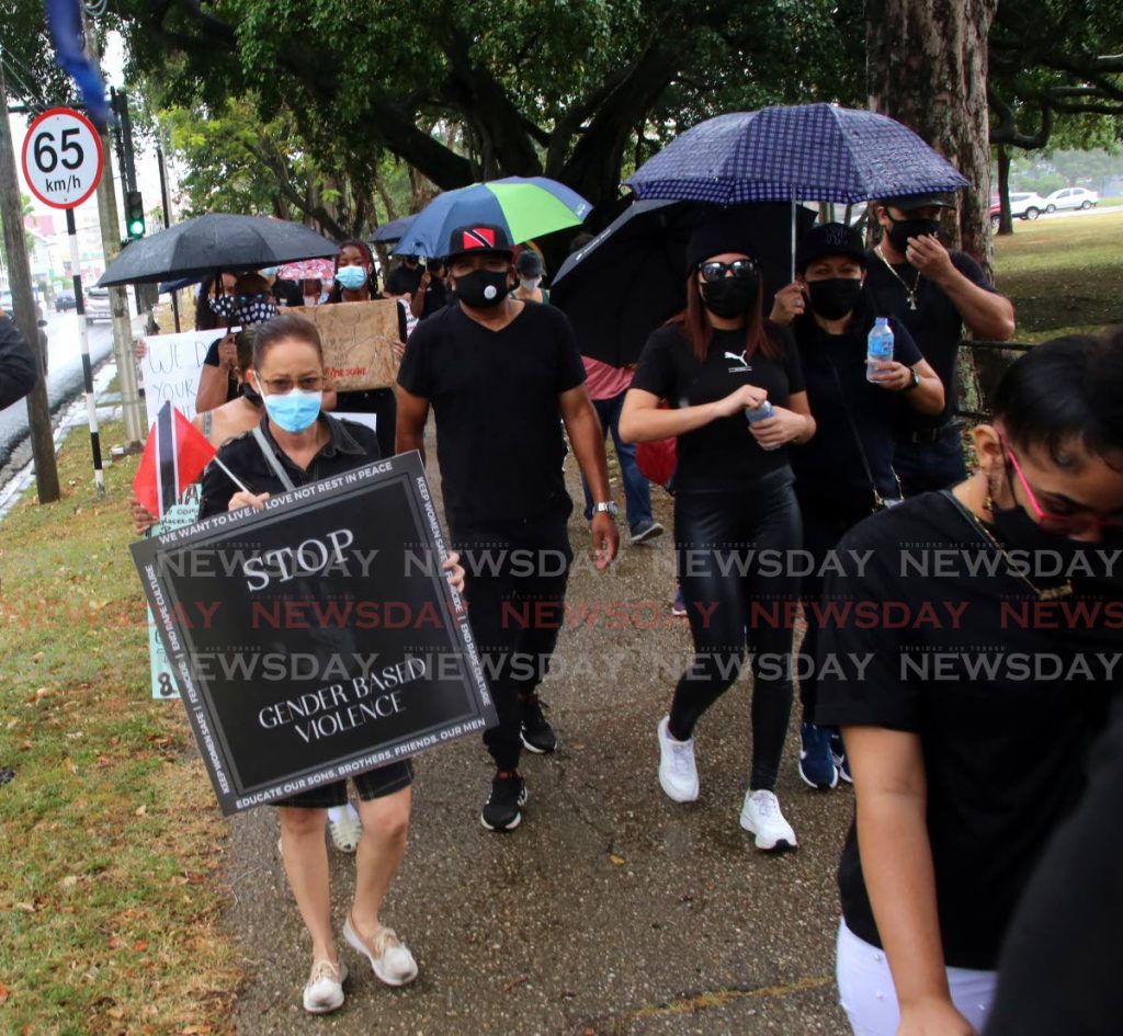 A protester carries a sign that says Stop Gender-Based Violence during a march from Queen's Park Savannah to the Red House, Port of Spain on Friday.  - 