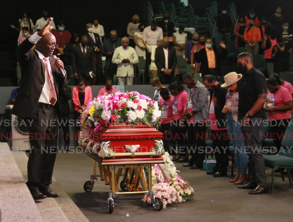 HEAR ME TT: Pastor Terrence William speaks near the sealed casket of murder victim Andrea Bharatt during her funeral on Friday at the Faith Assembly International Church in Arouca. PHOTO BY ROGER JACOB - 