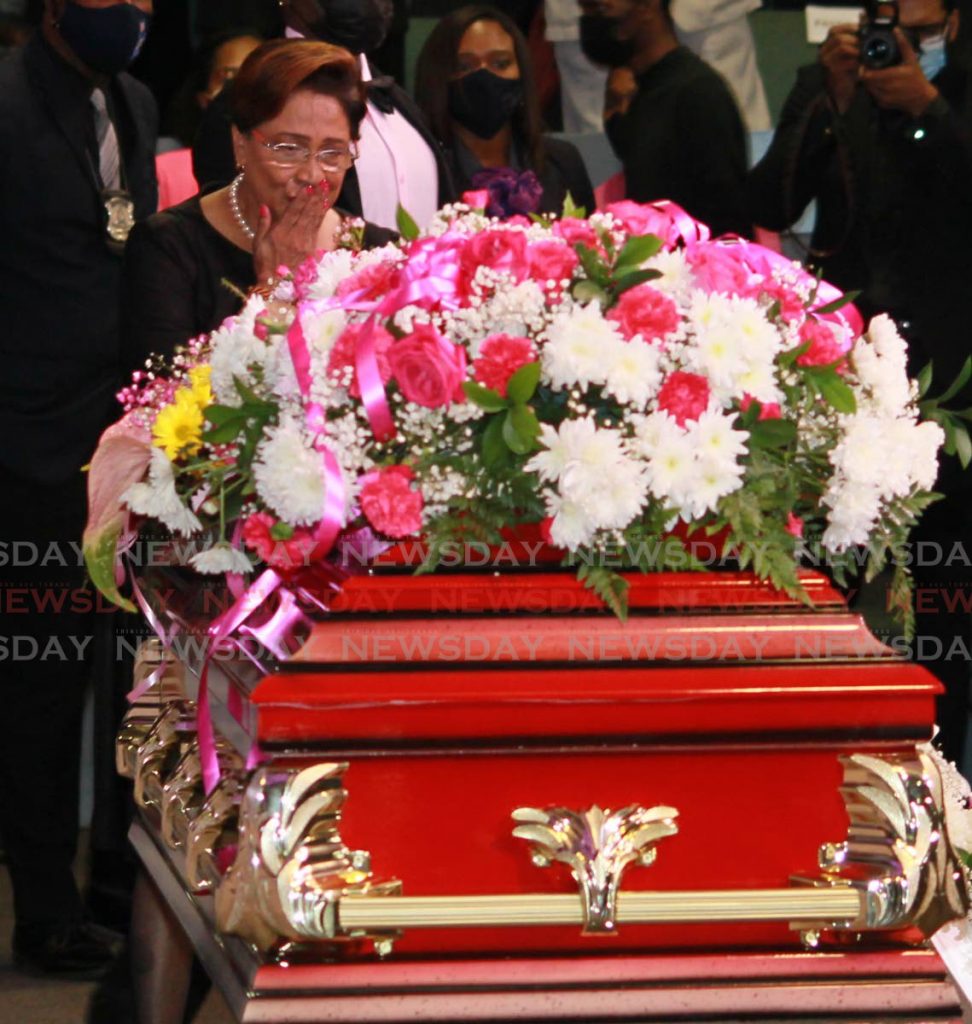 FAREWELL: Opposition Leader Kamla Persad-Bissessar blows a kiss at the sealed coffin of Andre Bharatt on Friday at the funeral in Arouca. PHOTO BY ROGER JACOB - 