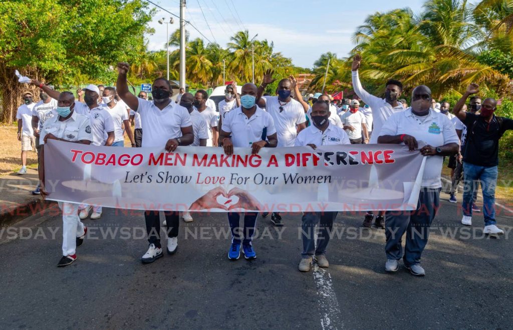 Activists under the umbrella – Tobago Men Making a Difference – lead a march against gender-based violence from Milford Road to Store Bay in Crown Point on Saturday. PHOTO BY DAVID REID - 