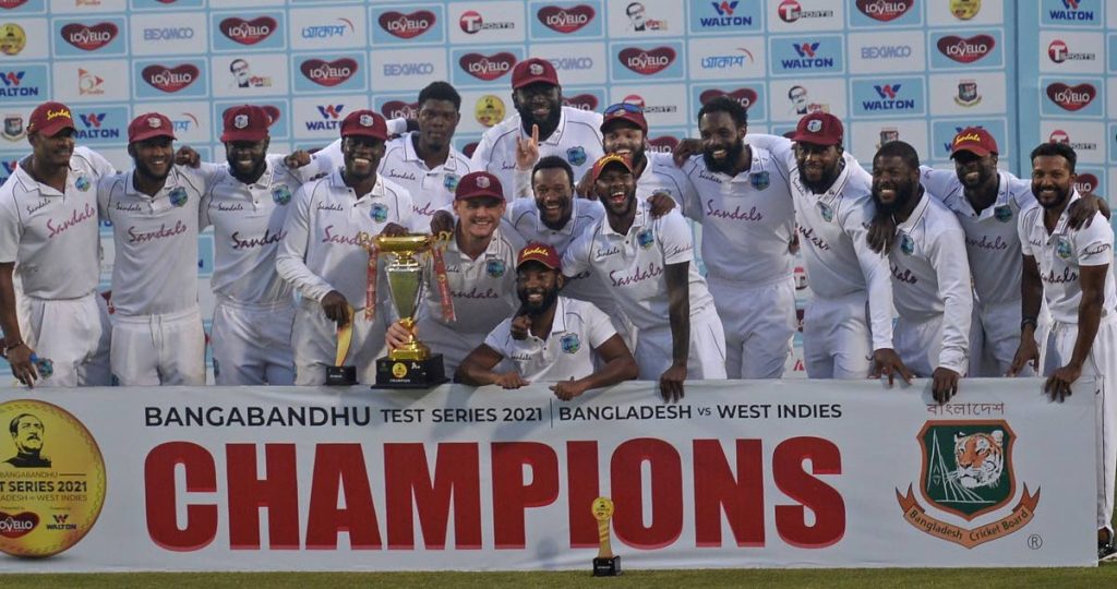 West Indies players celebrate with the trophy after winning the Test series against Bangladesh 2-0 at the Sher-e-Bangla National Cricket Stadium in Dhaka, Bangladesh in February 2021.  Photo courtesy CWI