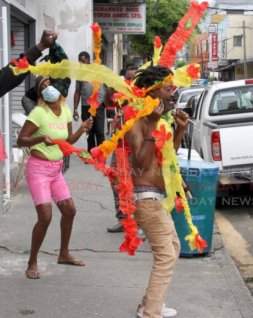 A man and a woman dance on Henry Street, Port of Spain on Monday to relieve their Carnival tabanca hit. Carnival 2021 was officially cancelled because of the covid19 pandemic. PHOTO BY ANGELO MARCELLE - 