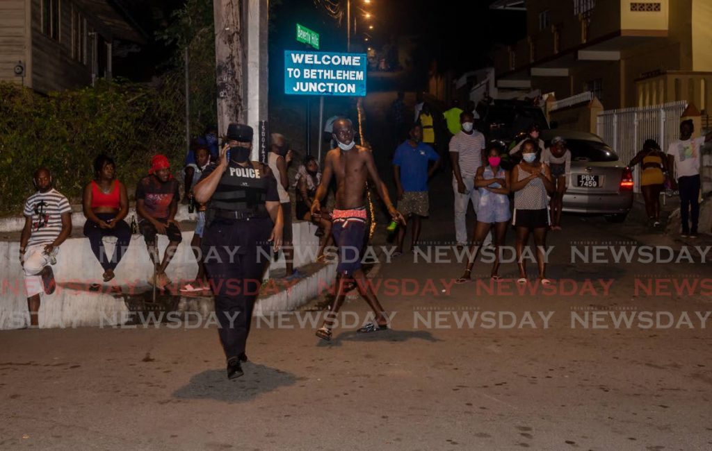 Residents of Bethel look on as police cordon off the scene after a multiple shooting on Monday night. - DAVID REID