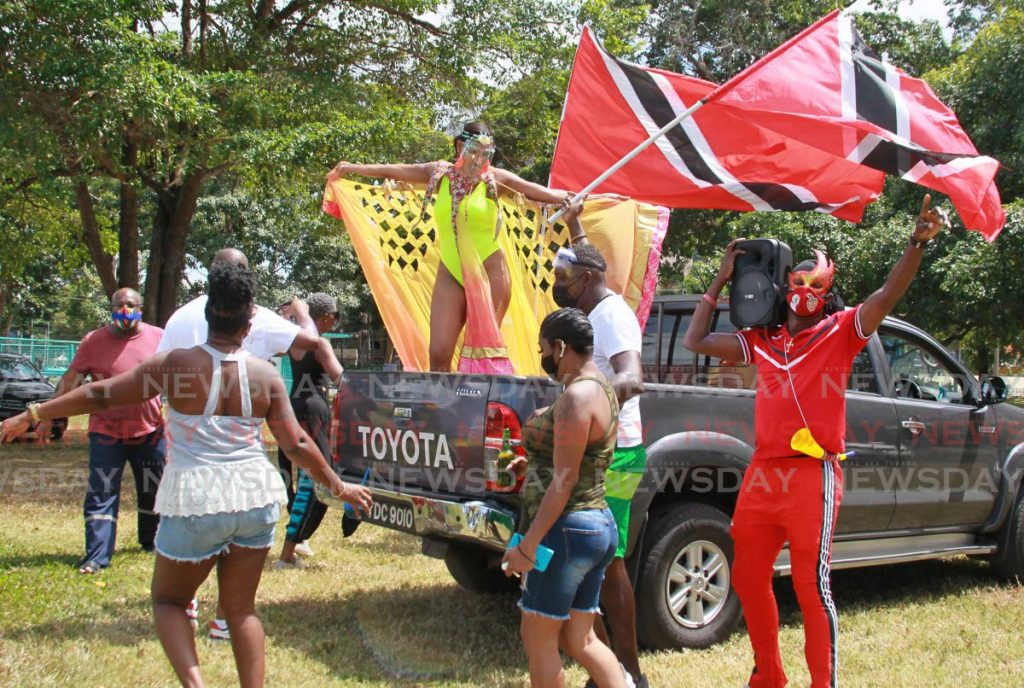 Revellers have fun around a van at the Queen's Park Savannah as they enjoy music from NEXT 99.1FM broadcasting from a YUMA truck nearby. PHOTO BY ROGER JACOB  - 