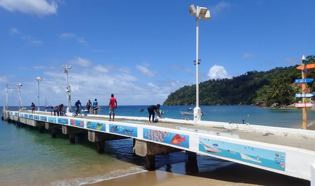 Charlotteville Jetty with murals showing fishing boats, yachts and natural heritage in the North East Tobago UNESCO Man and the Biosphere Area. - 