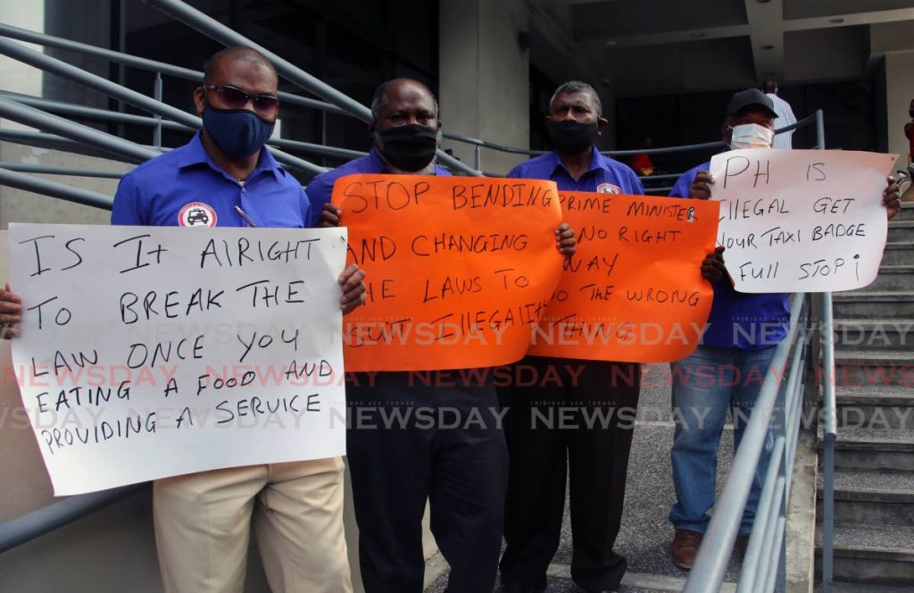 Executive members of the Taxi Drivers Network, from left, Jason Wickham,  Adrian Acosta, Chandrath Rampersad and Dennis Jagesser outside the Ministry Of Works And Transport, corner of Richmond and London St, Port of Spain, Wednesday. PHOTO BY SUREASH CHOLAI - 