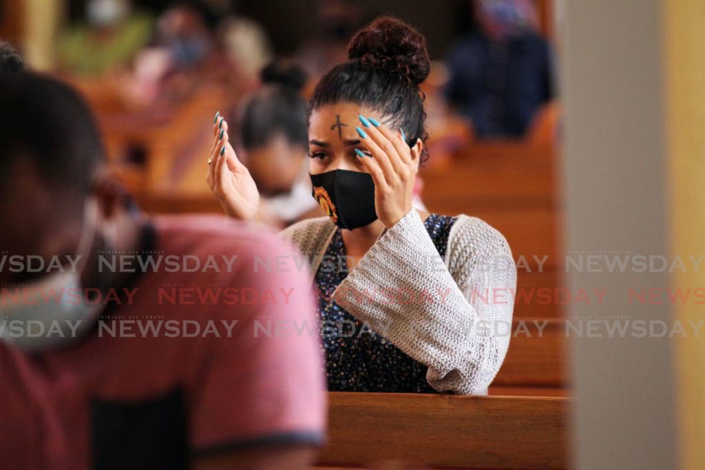 A parisonhner who received ashes on her forehead during the Ash Wednesday  service held at Our Lady of Perpetual Help church Harris promenade, San Fernando. - Lincoln Holder