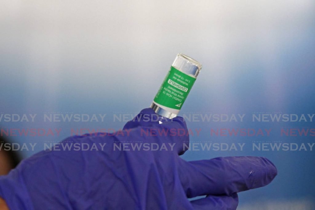 In this February 28 file photo, a health worker examines one of the Oxford Astrazeneca covid19 vaccines earlier this month when healthcare workers were administered the shots at the Couva Hospital. Photo by Marvin Hamilton